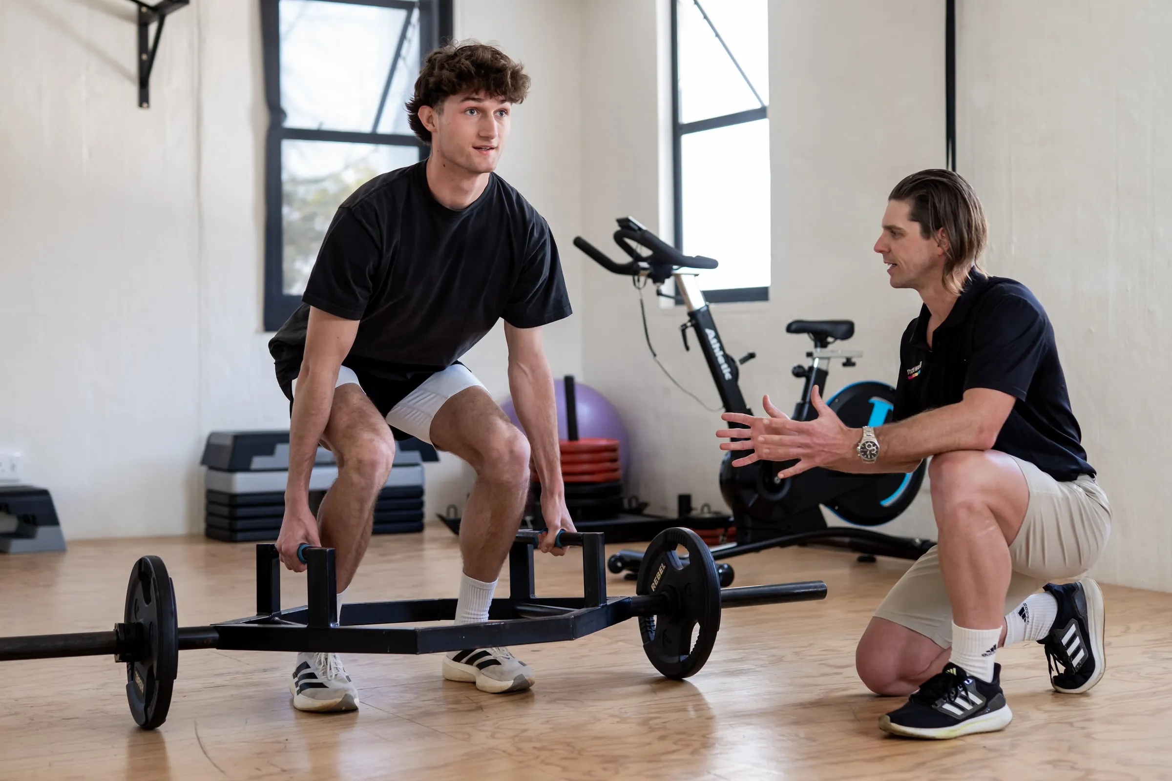 A Movewell clinician coaching a patient through a strength exercise
